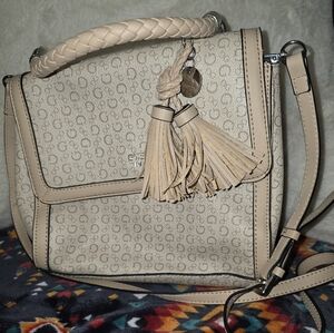 Beige Designer Handbag with Tassel Accent. GUESS 1981